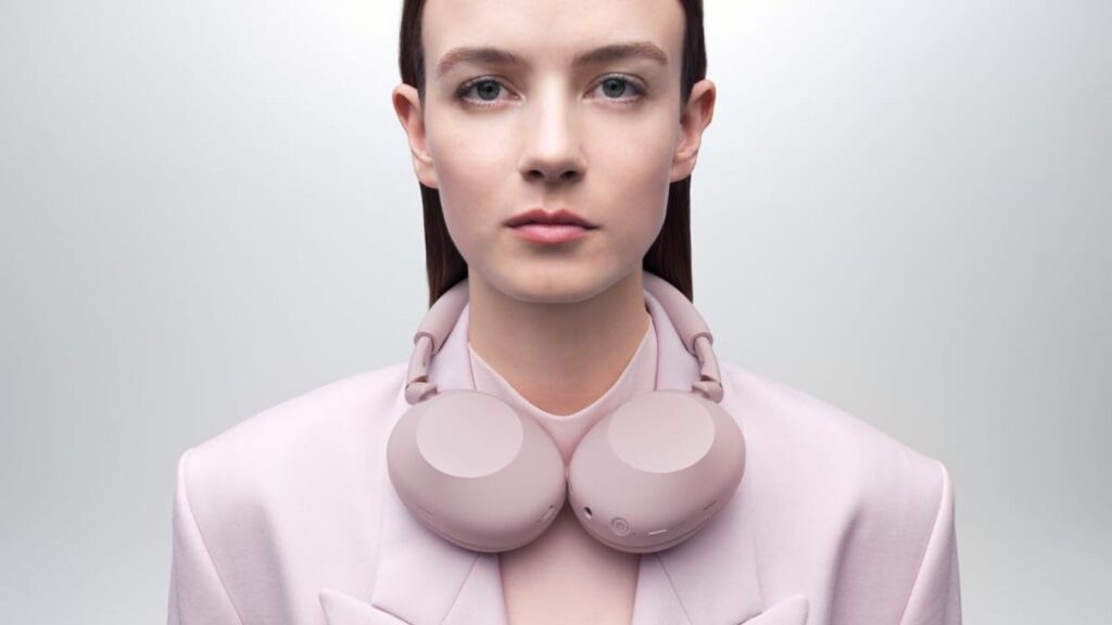 Sony WH-1000XM6 Sand Pink headphones on a pink background, showcasing the elegant color and design