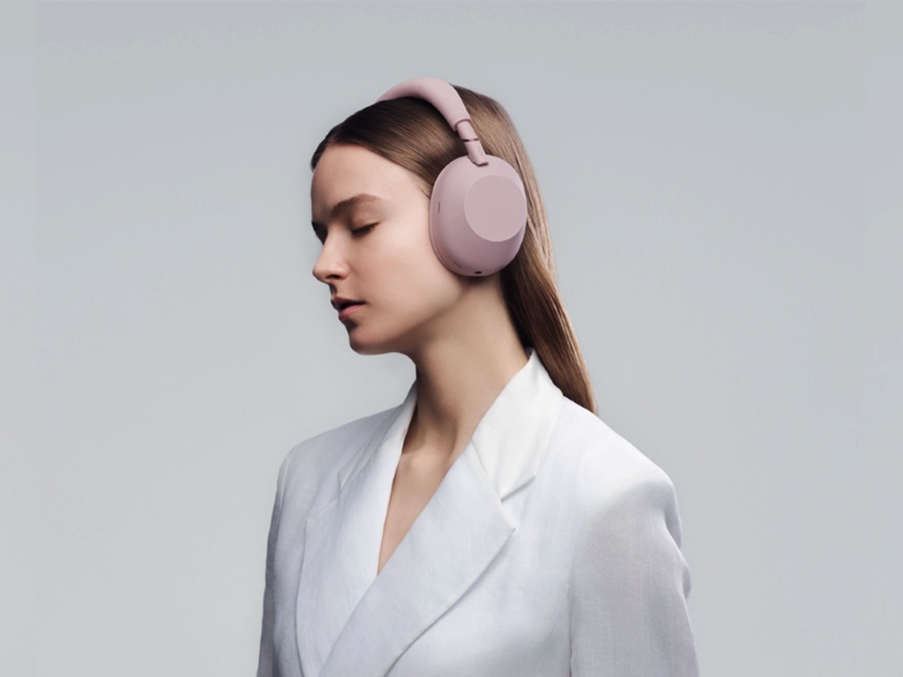 Close-up comparison of Sony WH-1000XM6 in Sand Pink next to a black version, highlighting the color difference